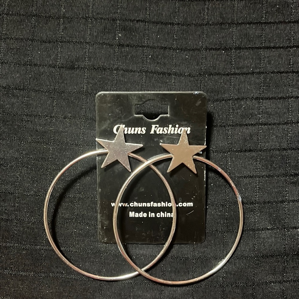 Silver toned stars atop large hoop earrings